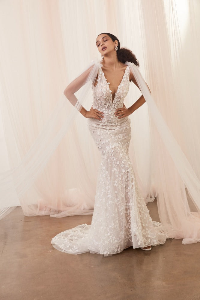 Model wears Saige gown with soft tulle bridal wings extending from shoulders