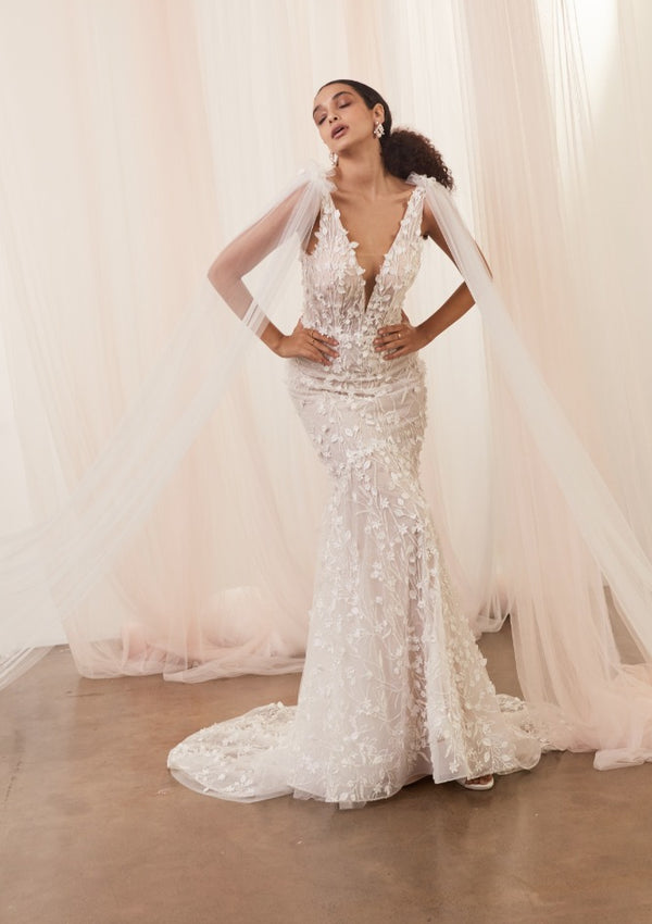 Model wears Saige gown with soft tulle bridal wings extending from shoulders