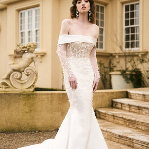 Model wears Theia gown with detachable sleeves made from matching lace. Sleeves fit under off-the-shoulder dress.