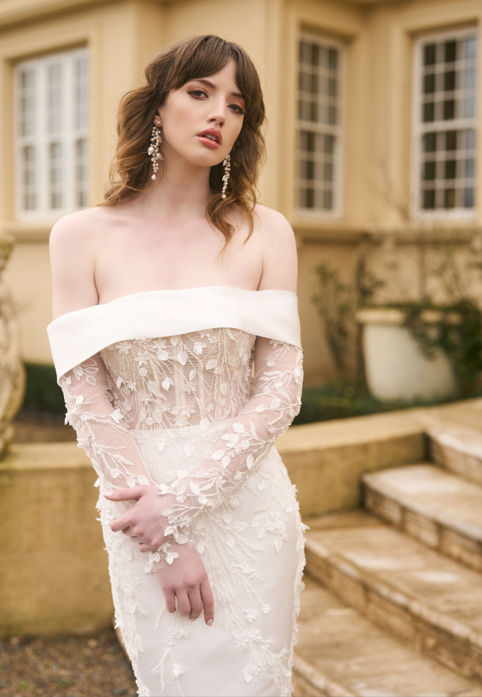 Model wears Theia wedding gown with detachable Theia Sleeves made from signature Jessica Couture lace. They are fitted underneath an off-the-shoulder gown