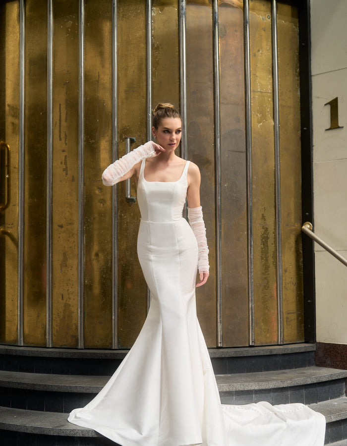 Square neckline fitted wedding dress with sheer pearl sleeves.