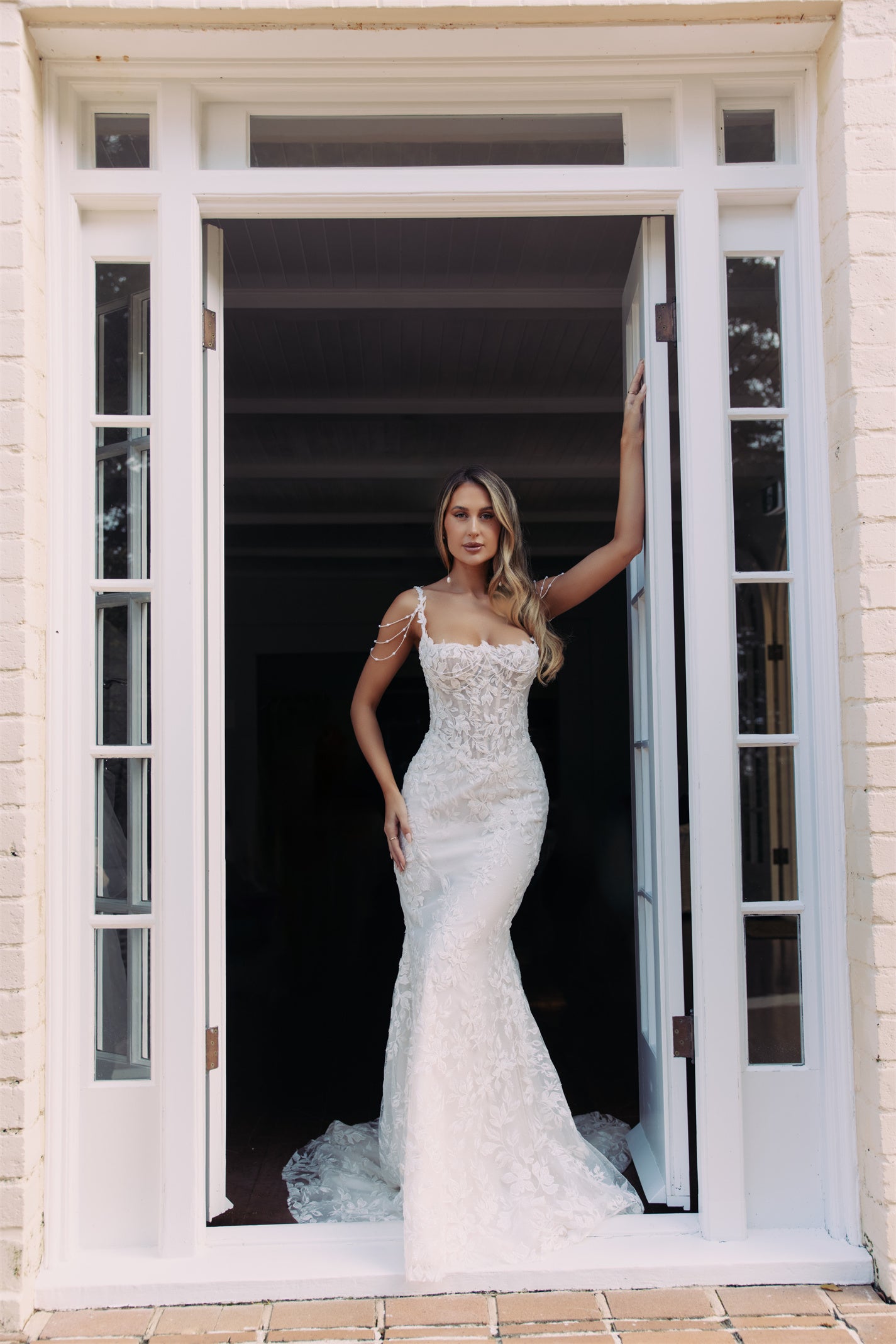 JOLIE Bridal Gown - Wedding dress by Victoria Collection Jessica Couture. Featuring an Fit-N-Flare floral lace gown with chapel train, and delicate pearl chains. 