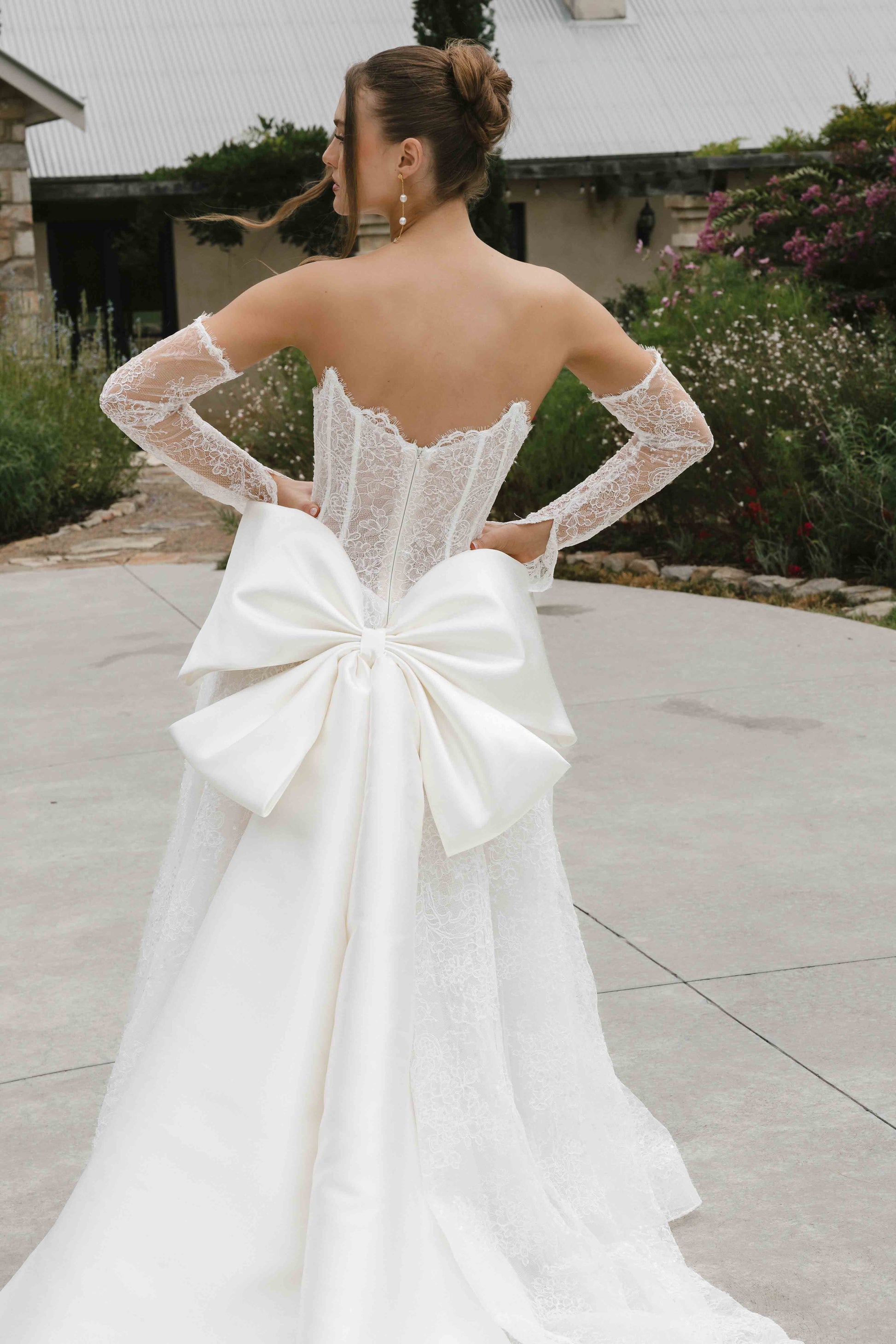 Caitlyn Gown – A-line lace bridal dress with a chapel train, matching lace gloves, and a V-plunge by Roselle collection Jessica Couture