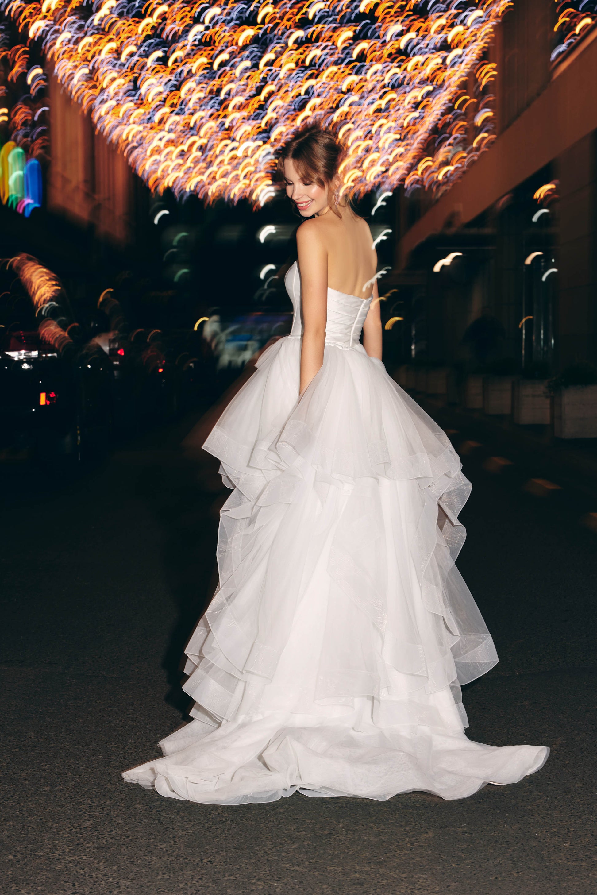 Mini Bridal dress featuring a ruffled tulle A line skirt and strapless corset bodice 