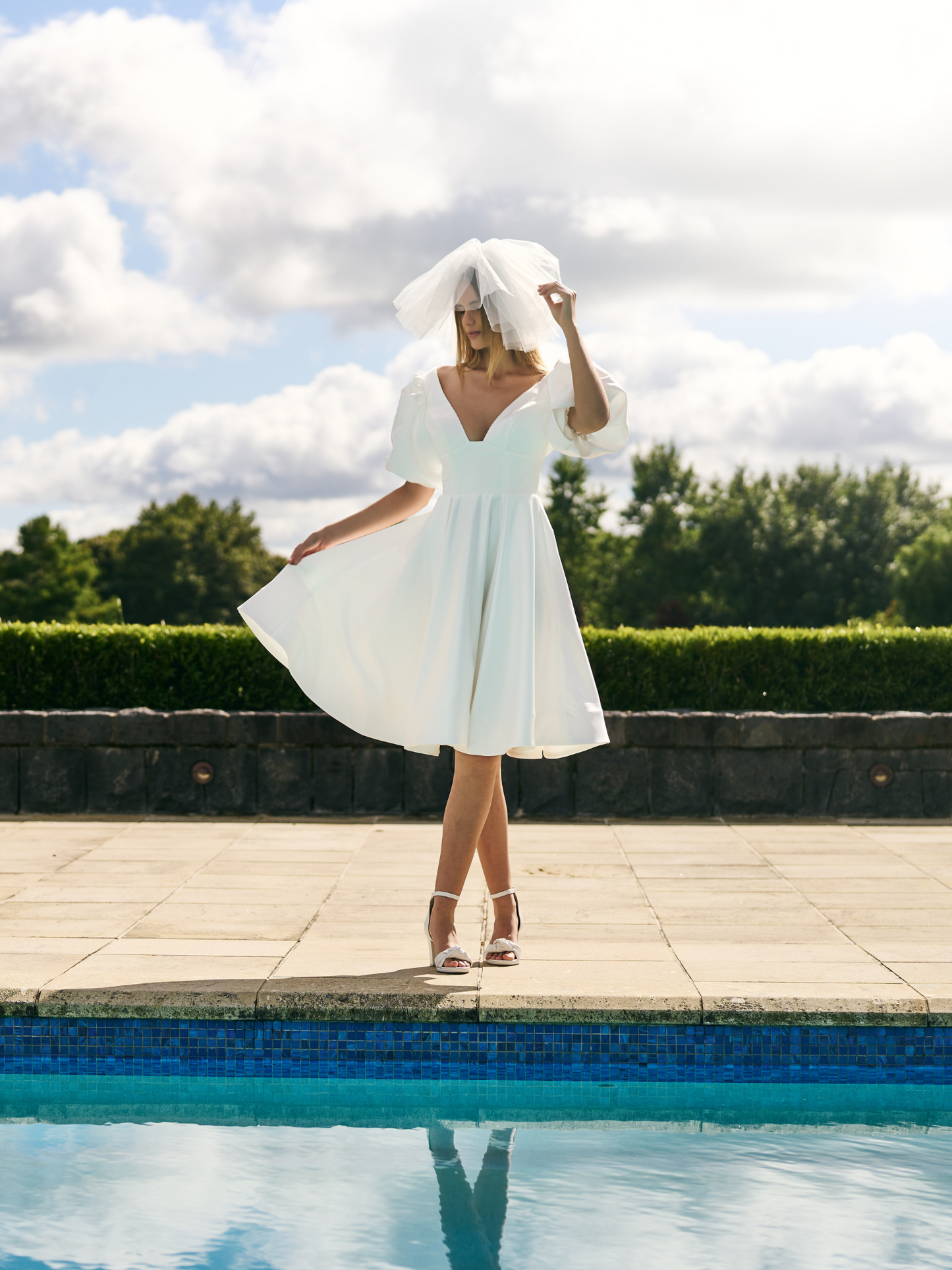 
Mini Bridal dress A-line skirt with puffed three quarter sleeves and V neck plunge. 
