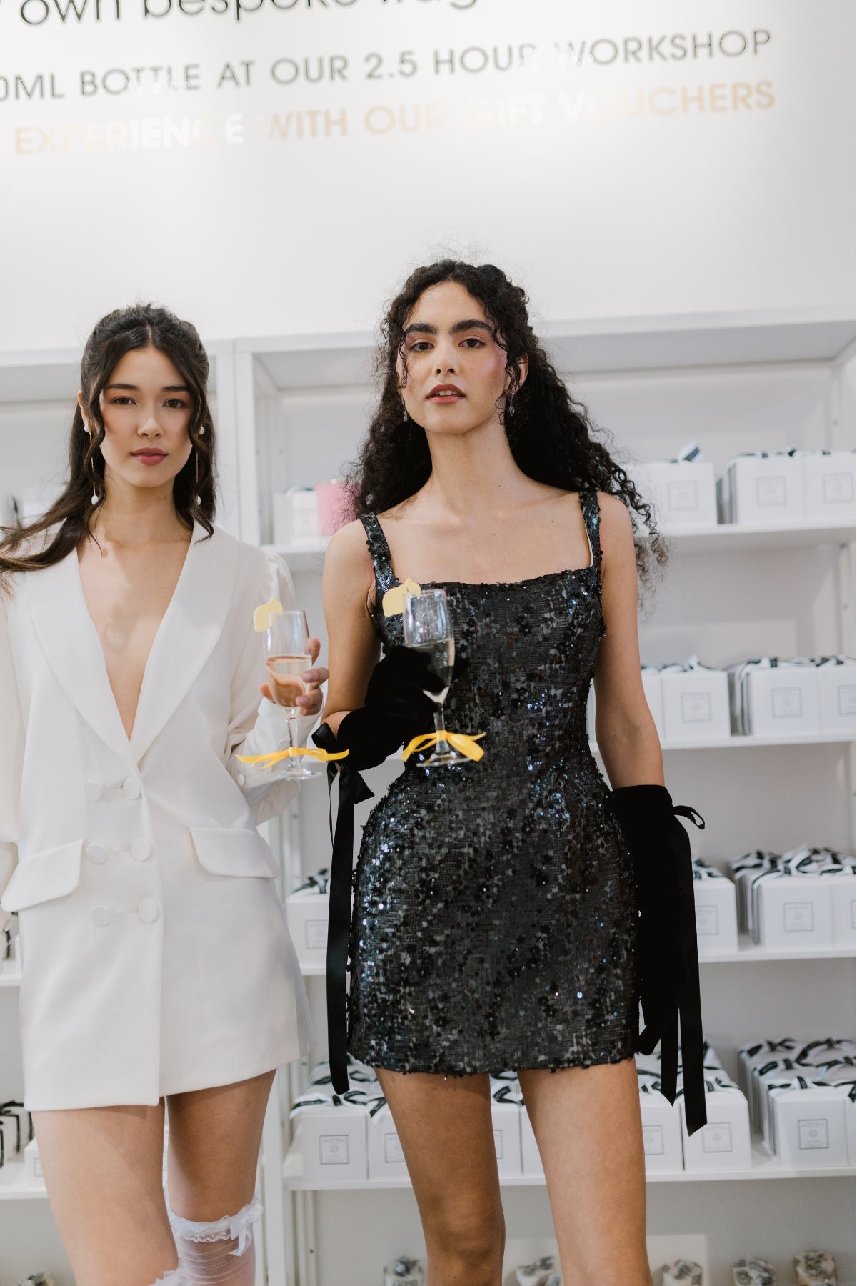 glittering black fitted mini dress with square neckline and straps. 