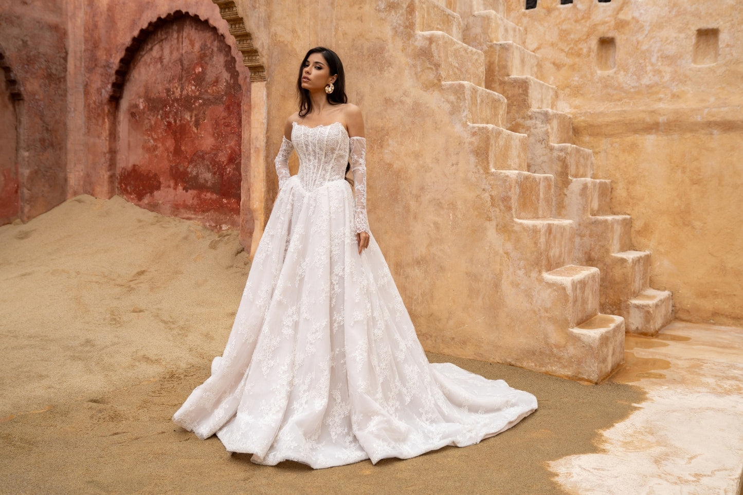 Lace A-line wedding dress with cat-eye neckline and basque waist. paired with fitted lace sleeves. 