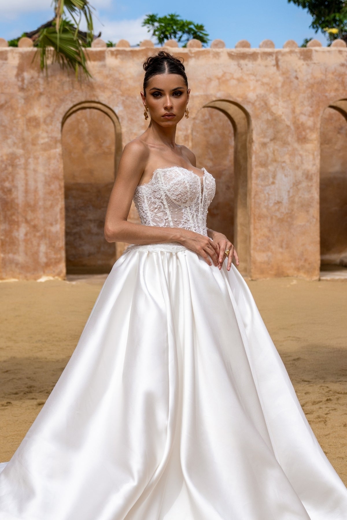 A-line wedding gown with lace bodice and plain skirt featuring basque waistline 