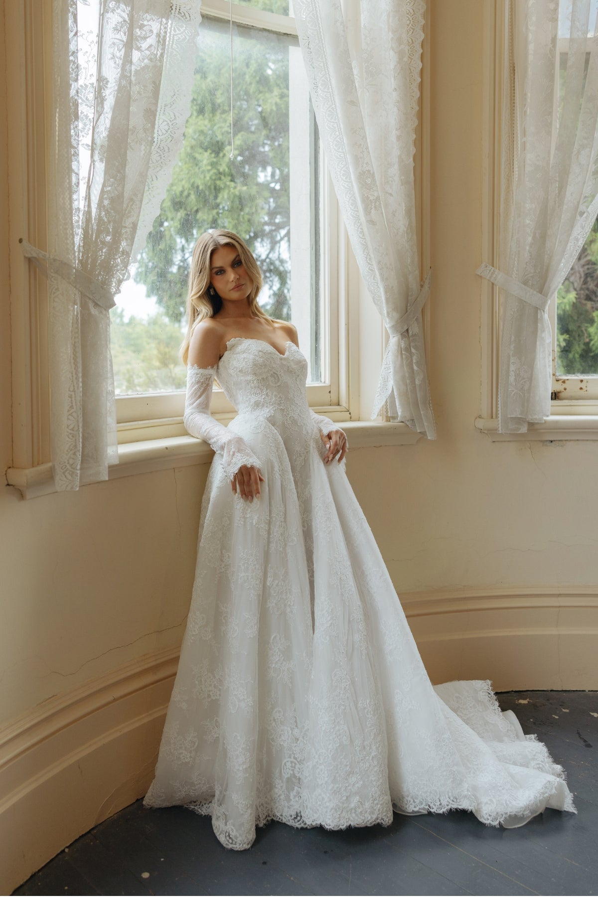 A-line wedding dress in lace, featuring a sweetheart neckline and steep basque waist, full of volume and drama. fitted lace sleeves included 