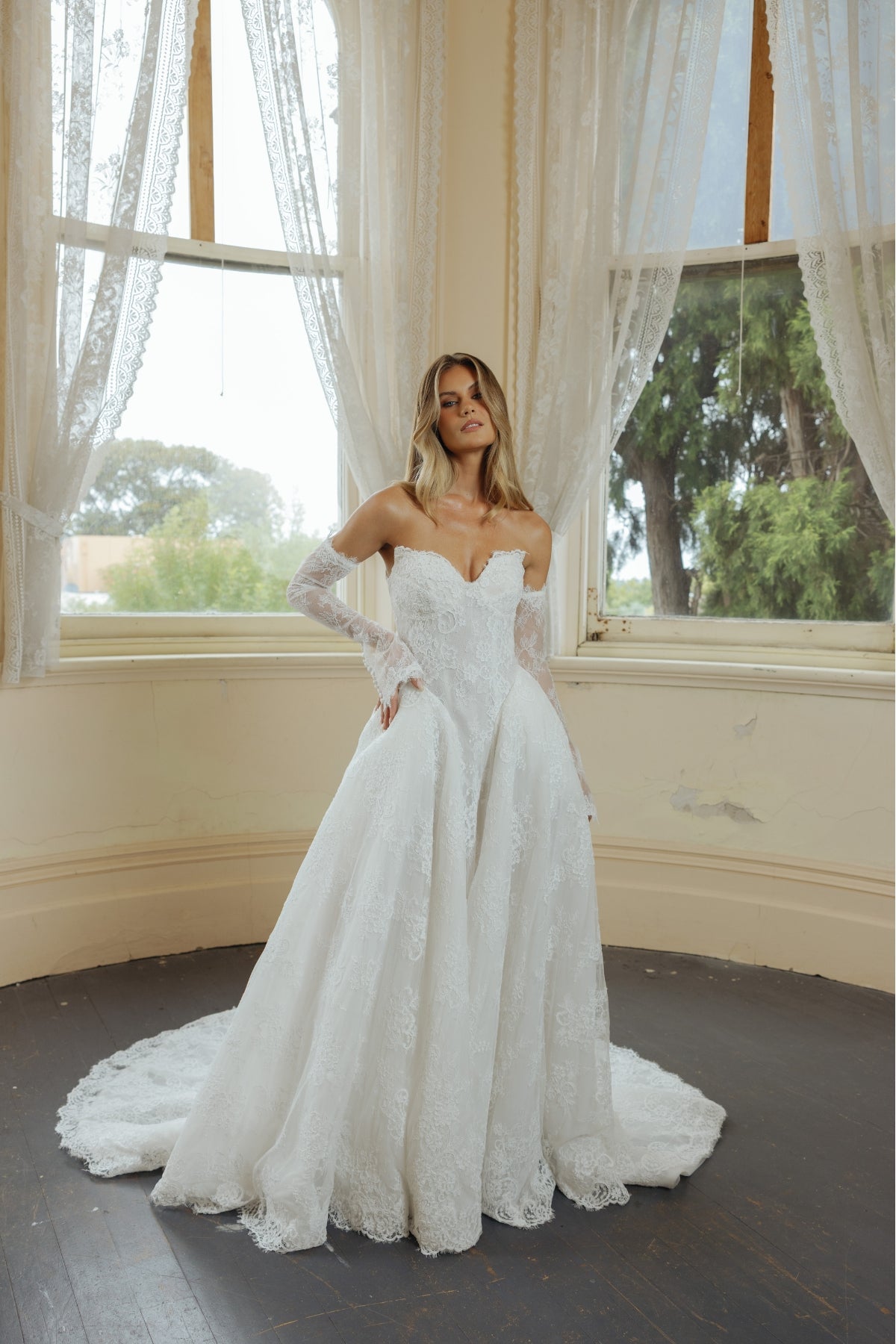 A-line wedding dress in lace, featuring a sweetheart neckline and steep basque waist, full of volume and drama. fitted lace sleeves included 