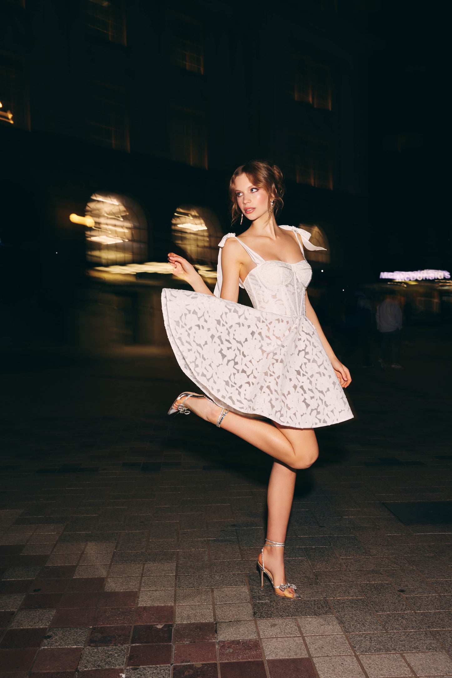 A-line mini Bridal dress with laser cut floral lace detailing featuring a
square neckline with ribbon straps 