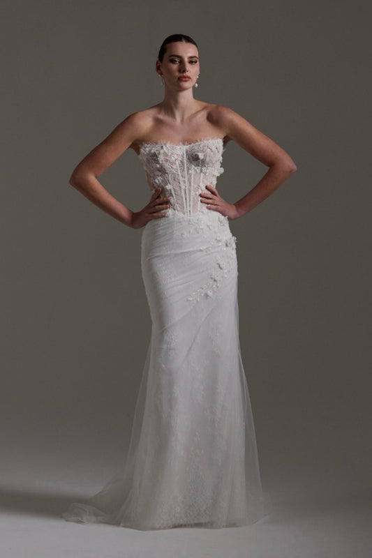 Fitted Bridal gown with floral lace scattered around the corseted bodice, basque waistline. 