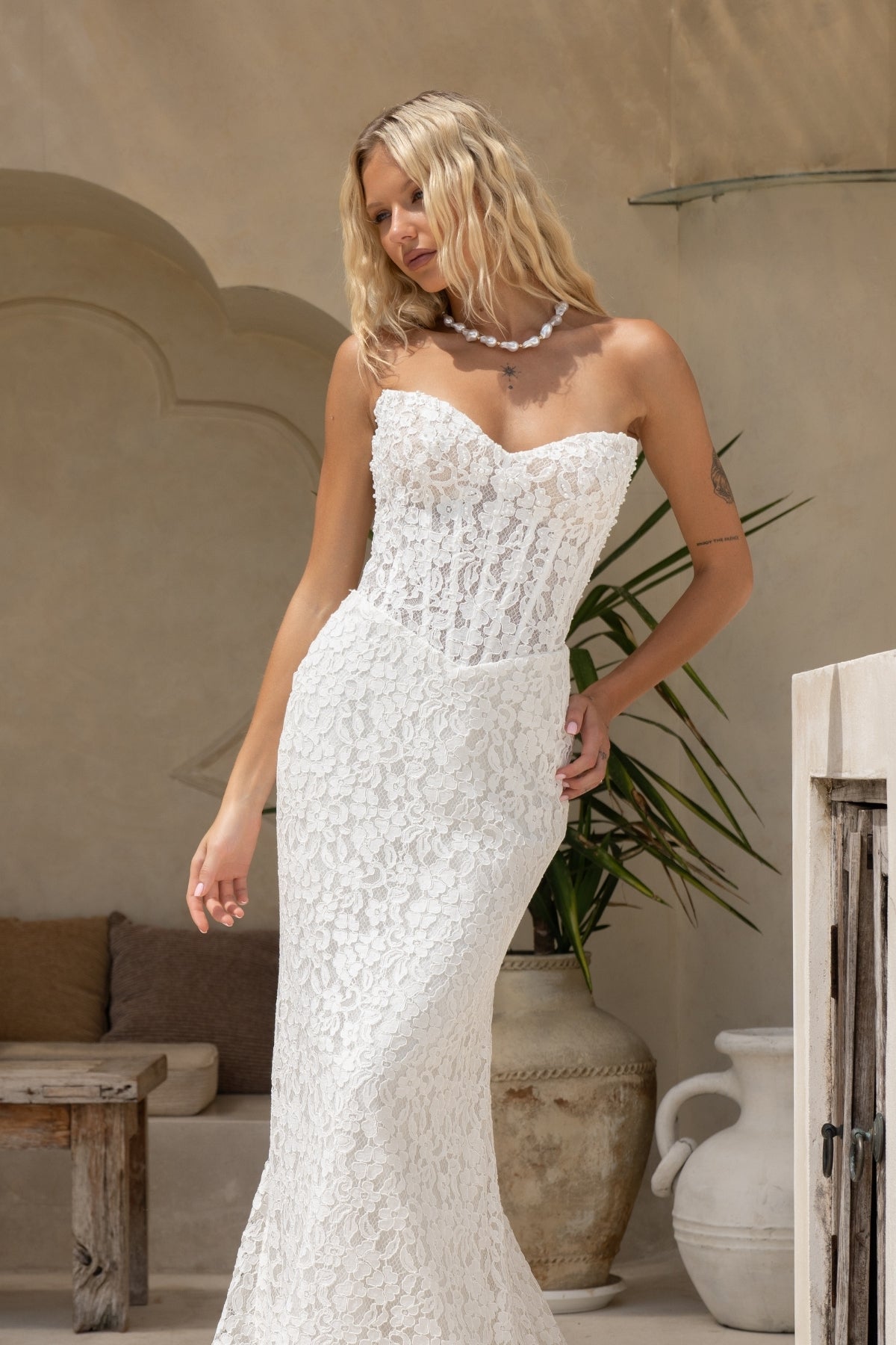 fitted lace wedding gown with sweetheart neckline and corseted bodice and basque neckline. 