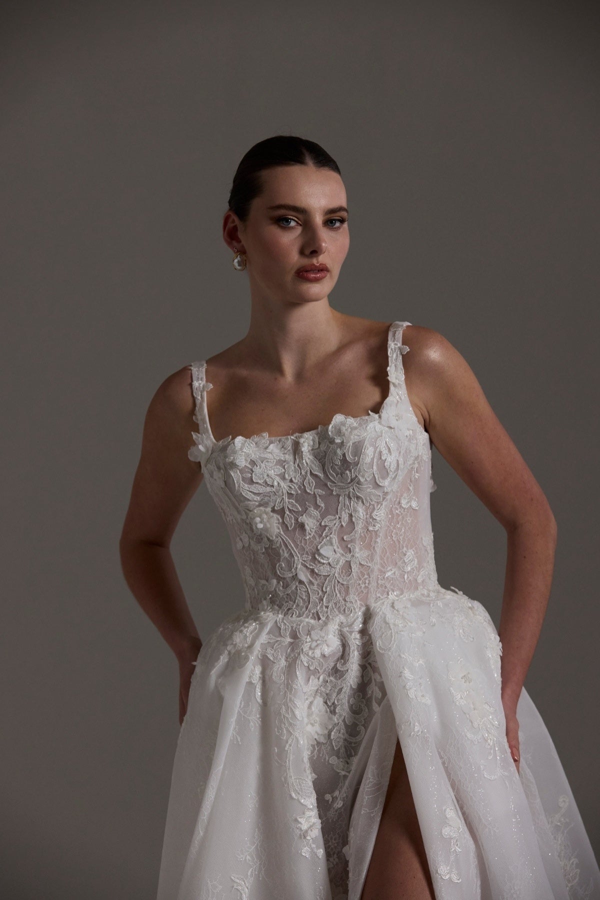 A-line Wedding gown featuring a square neckline, ballgown skirt, and lace. 