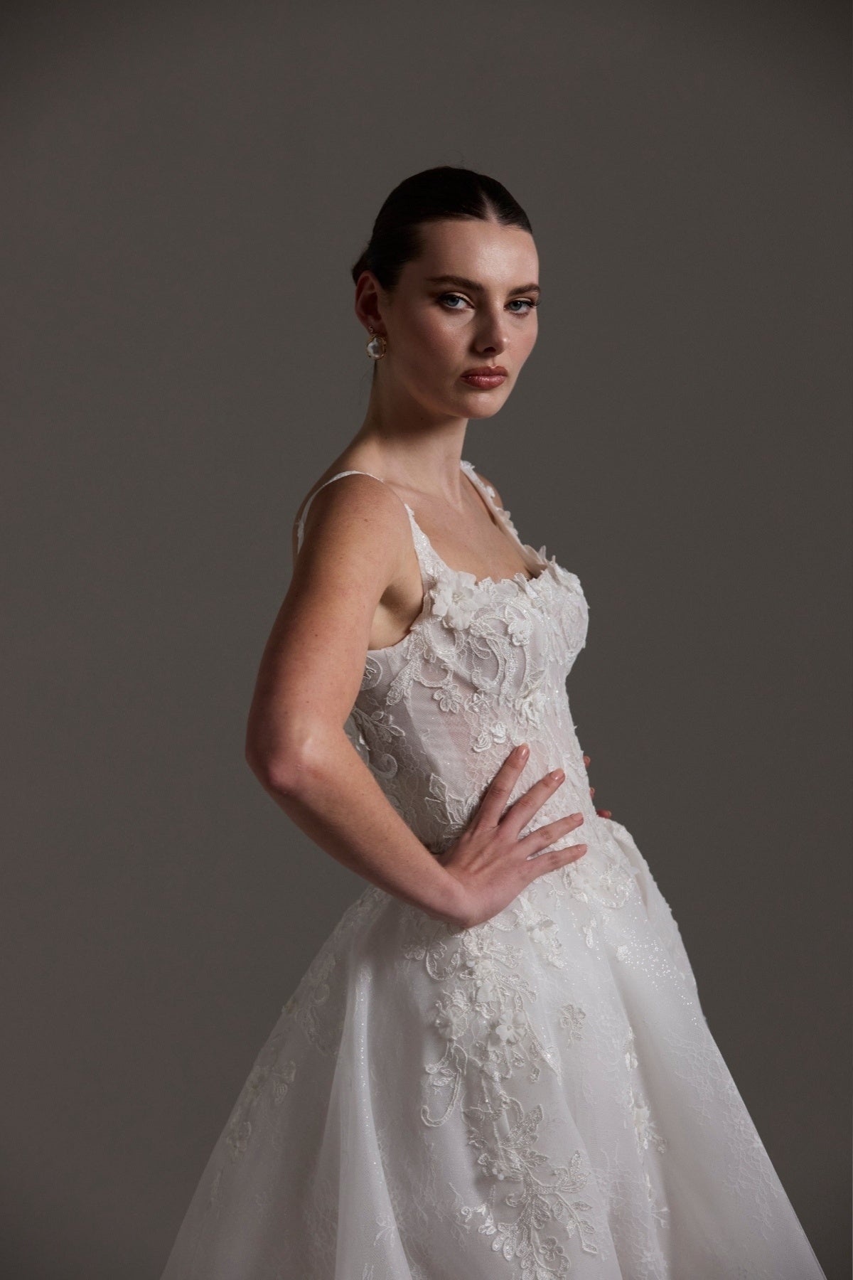 A-line Wedding gown featuring a square neckline, ballgown skirt, and lace. 