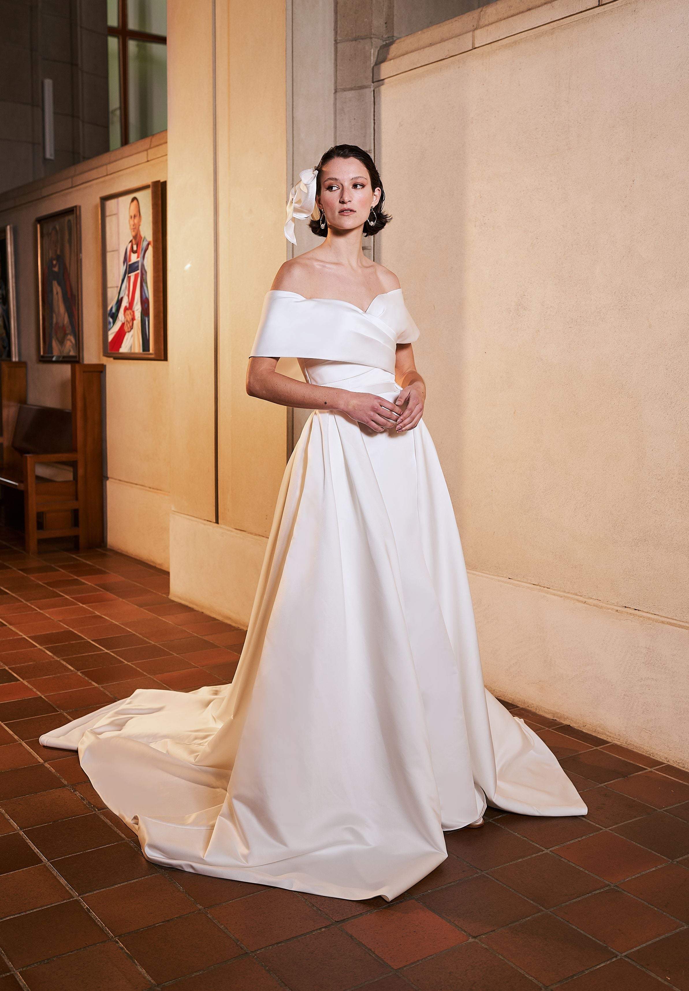 Serenity overskirt is attached to serenity wedding gown. Minimal aesthetic in ivory sating, this detachable overskirt joins at the waist creating a voluminous train