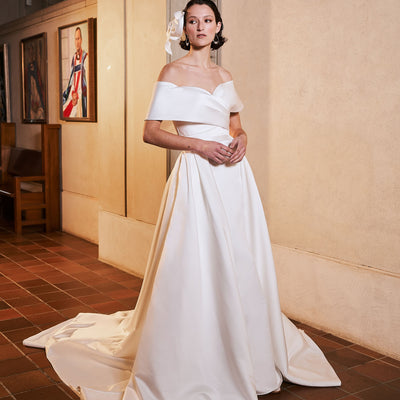 Serenity overskirt is attached to serenity wedding gown. Minimal aesthetic in ivory sating, this detachable overskirt joins at the waist creating a voluminous train