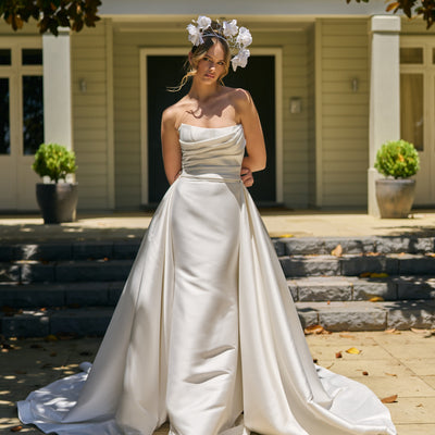 Model wears mikado wedding dress with Lisha overskirt. A detachable overskirt with lots of volume that trails behind.