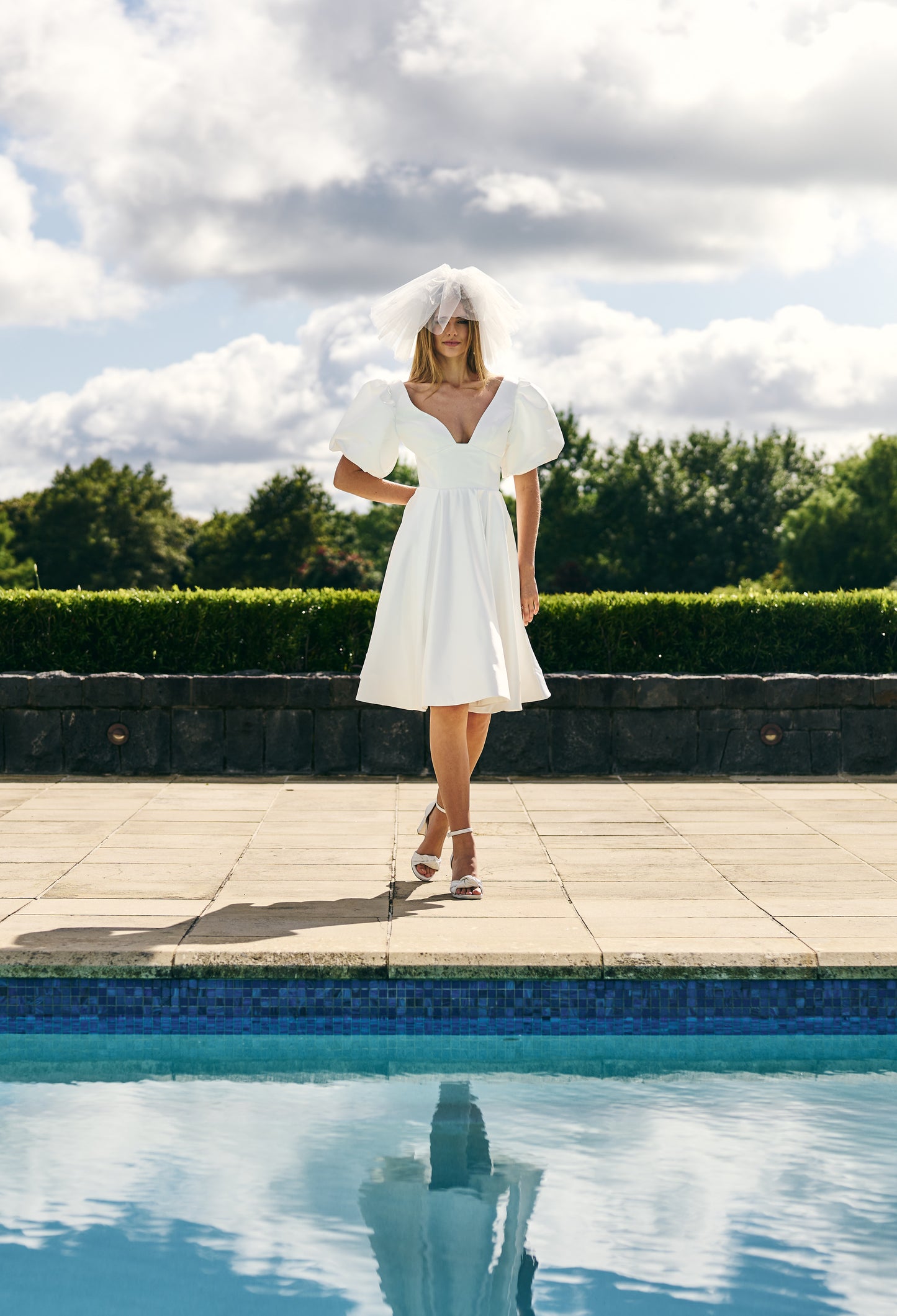 Mini Bridal dress A-line skirt with puffed three quarter sleeves and V neck plunge. 
