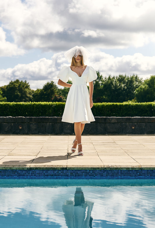 Mini Bridal dress A-line skirt with puffed three quarter sleeves and V neck plunge. 
