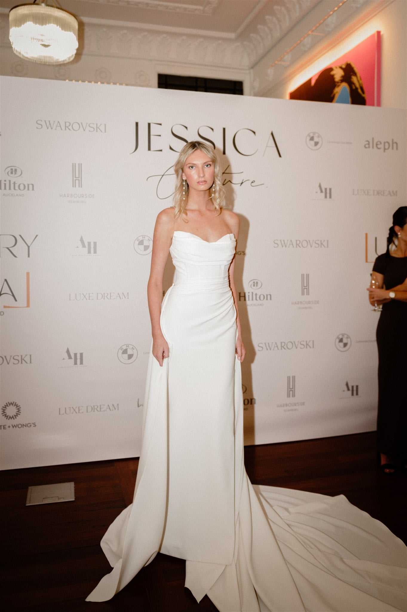 model wears ivory Cat eye strapless wedding dress with sheer mesh back and side split.
