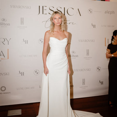 model wears ivory Cat eye strapless wedding dress with sheer mesh back and side split.