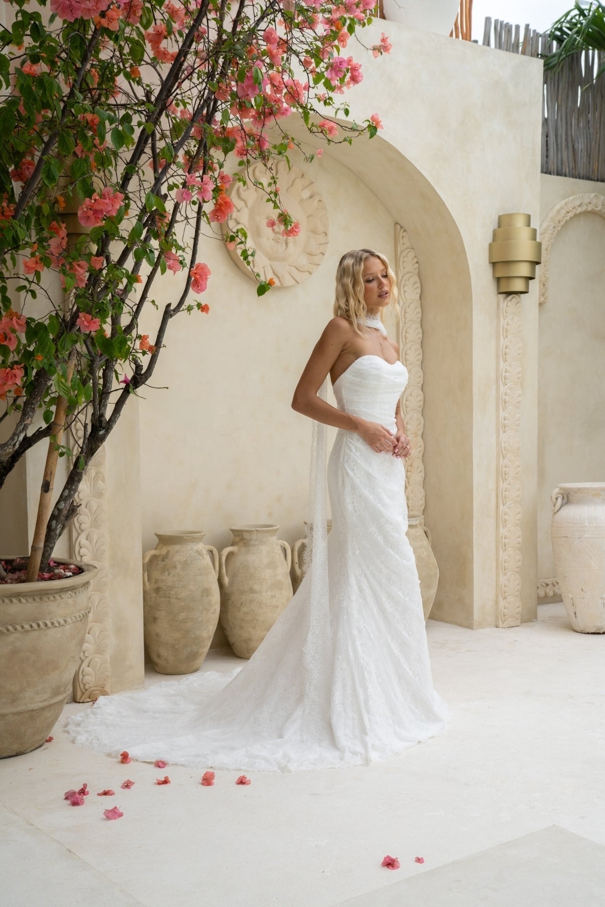 fitted lace wedding gown with sweetheart neckline, ruching across torso, paired with a lace scarf 