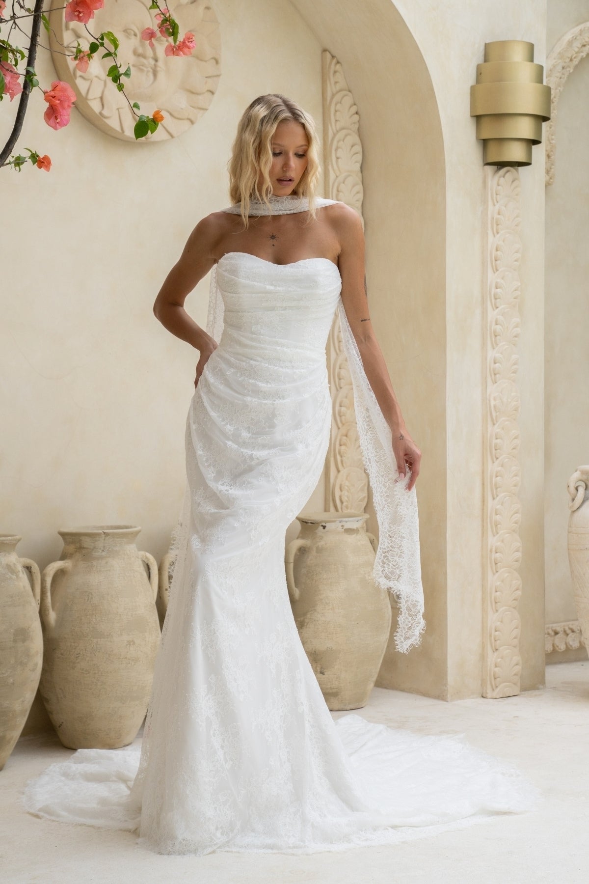 fitted lace wedding gown with sweetheart neckline, ruching across torso, paired with a lace scarf 