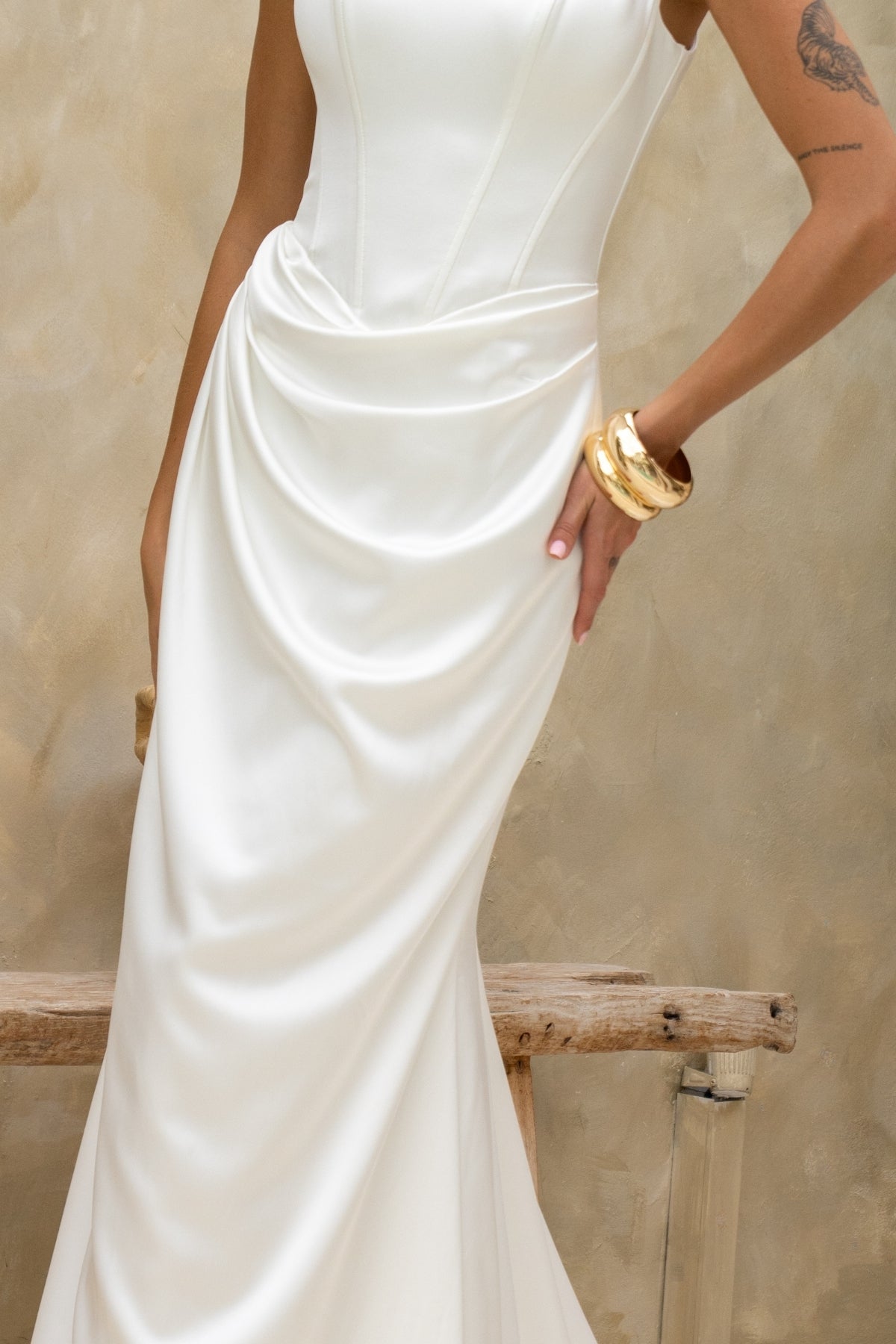 fitted plain wedding dress featuring square neckline with straps, boning on bodice and slight drape around the hips. minimal vibes 