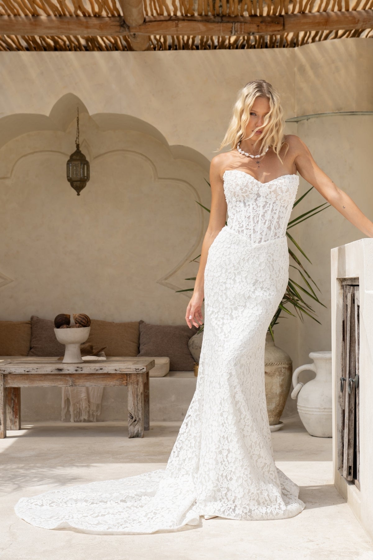 fitted lace wedding gown with sweetheart neckline and corseted bodice and basque neckline. 