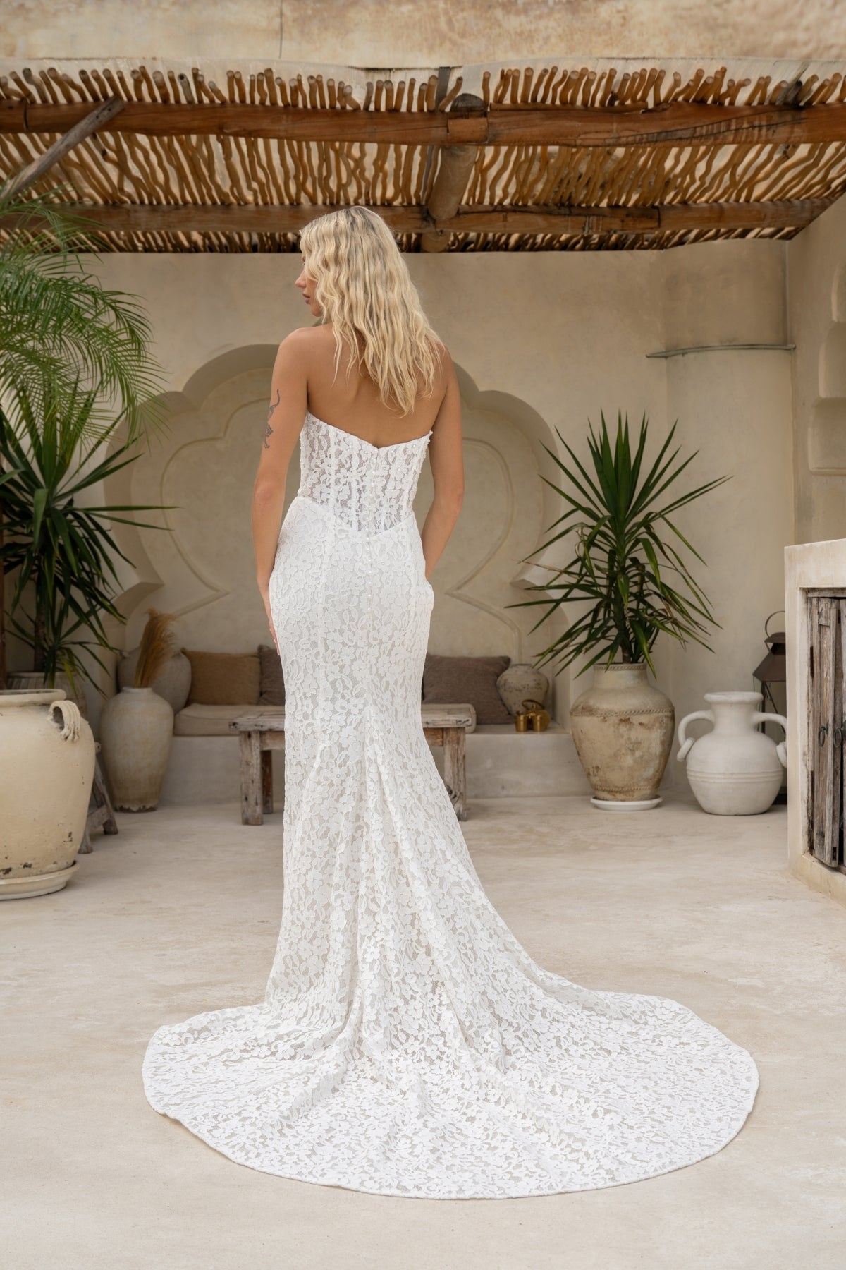 fitted lace wedding gown with sweetheart neckline and corseted bodice and basque neckline. 