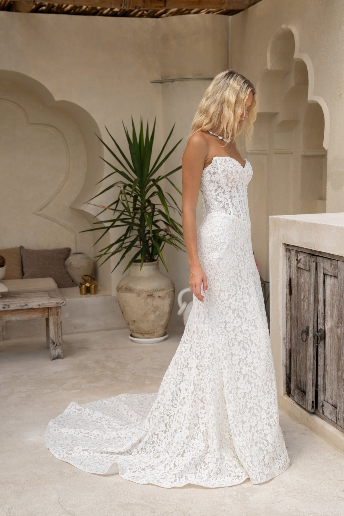 fitted lace wedding gown with sweetheart neckline and corseted bodice and basque neckline. 