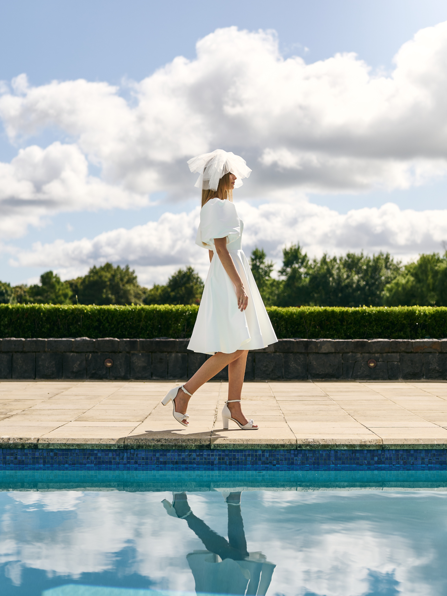 
Mini Bridal dress A-line skirt with puffed three quarter sleeves and V neck plunge. 
