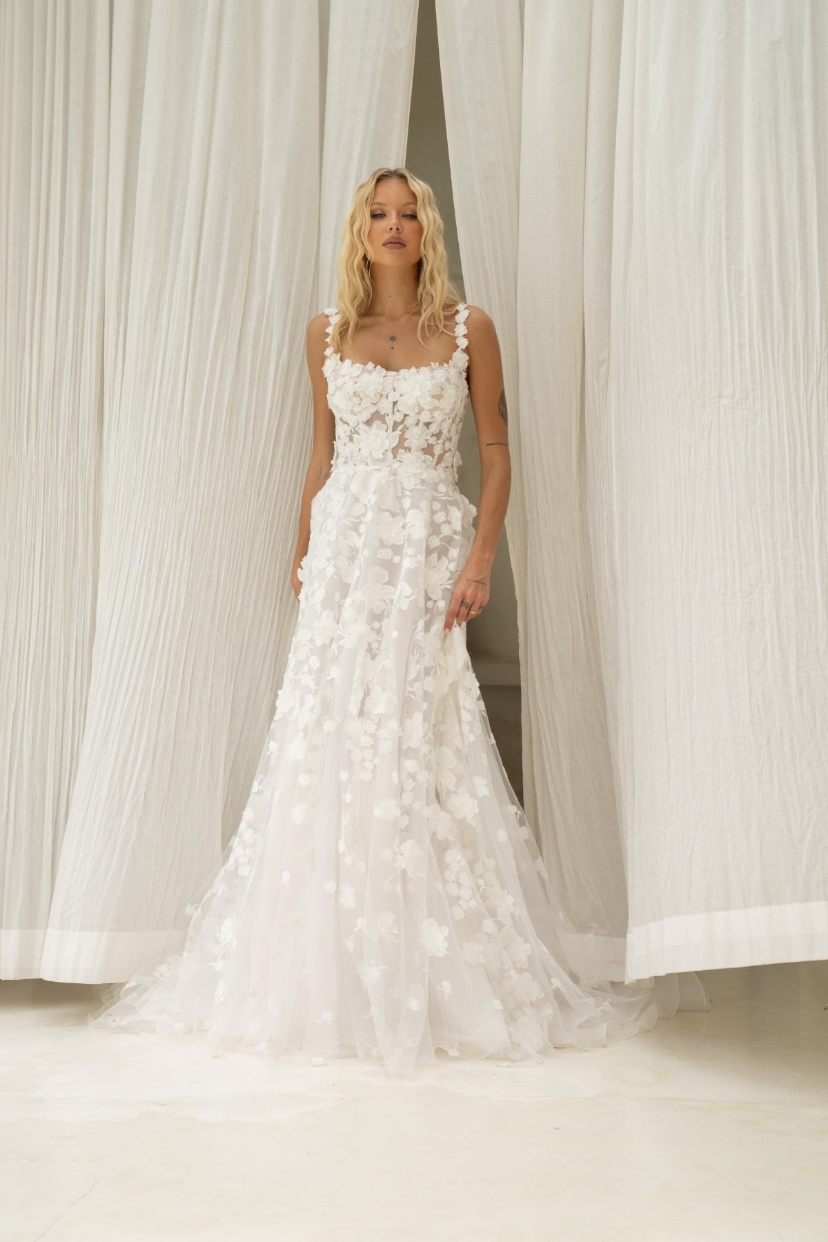 A-line wedding dress covered in 3D floral lace, square neckline with straps. 