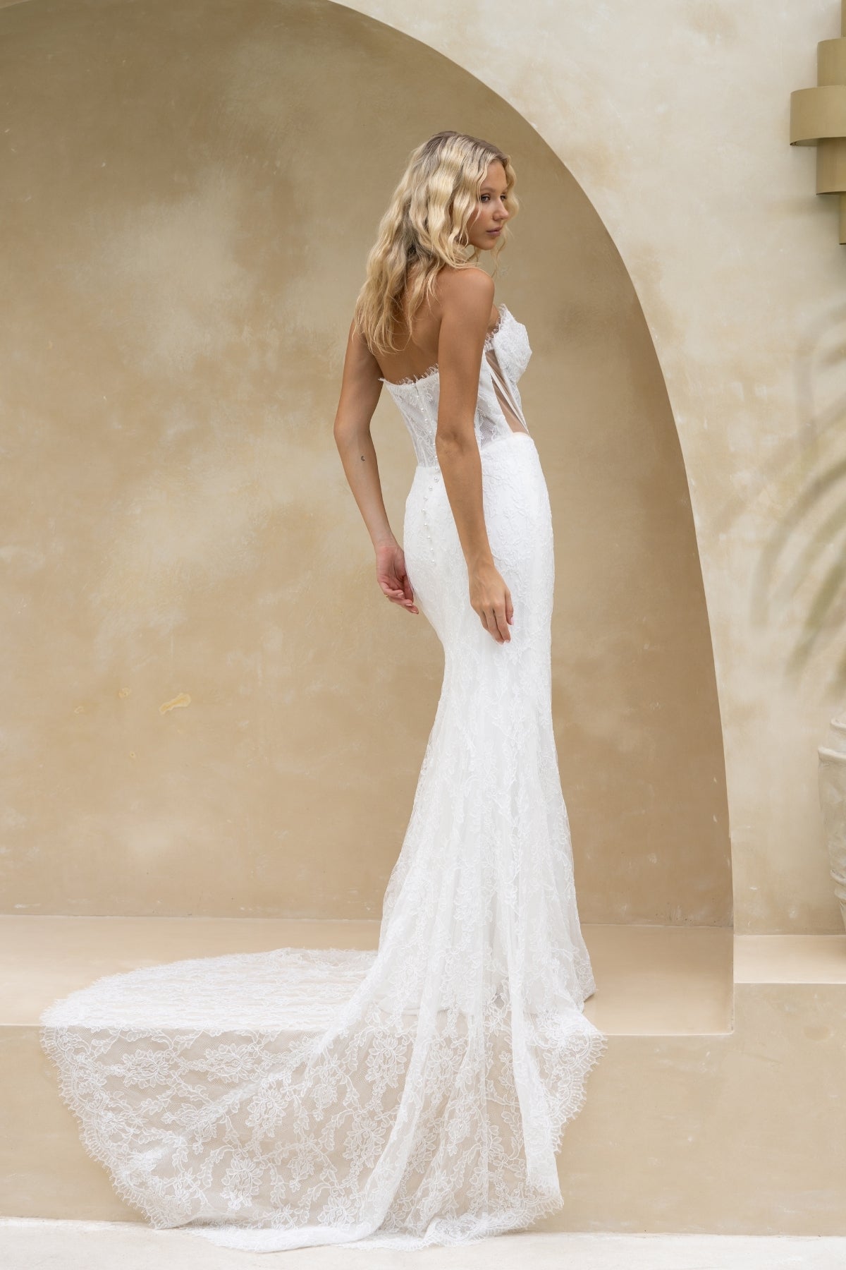 fitted lace wedding gown with ruched bust, sweetheart neckline, and sheer side cut outs with corset boning. featuring a slight basque waist