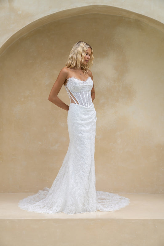 fitted lace wedding gown with ruched bust, sweetheart neckline, and sheer side cut outs with corset boning. featuring a slight basque waist
