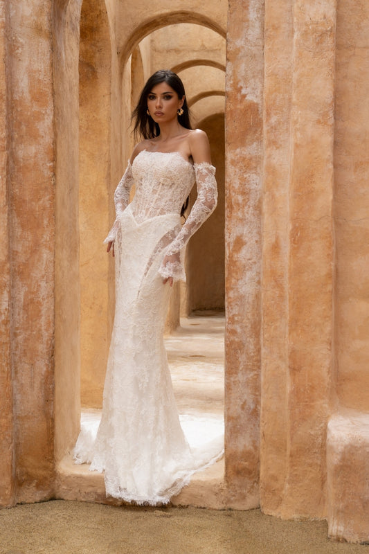 fitted lace wedding dress with basque waist, cat-eye neckline and side cut-outs. paired with fitted lace sleeves. 