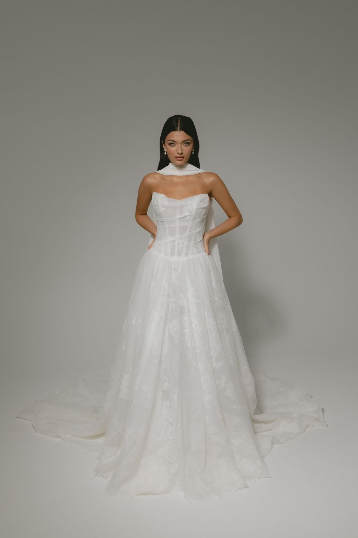 A-line wedding gown, subtle floral pattern, strapless corset boning bodice. paired with a chiffon scarf 