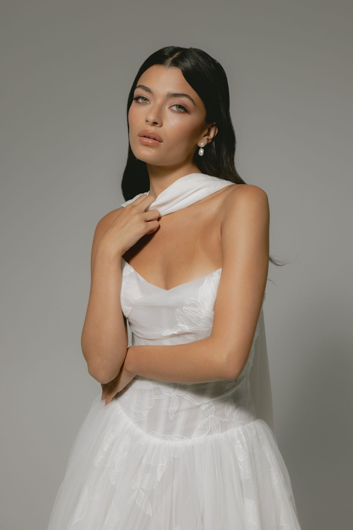 A-line wedding gown, subtle floral pattern, strapless corset boning bodice. paired with a chiffon scarf 