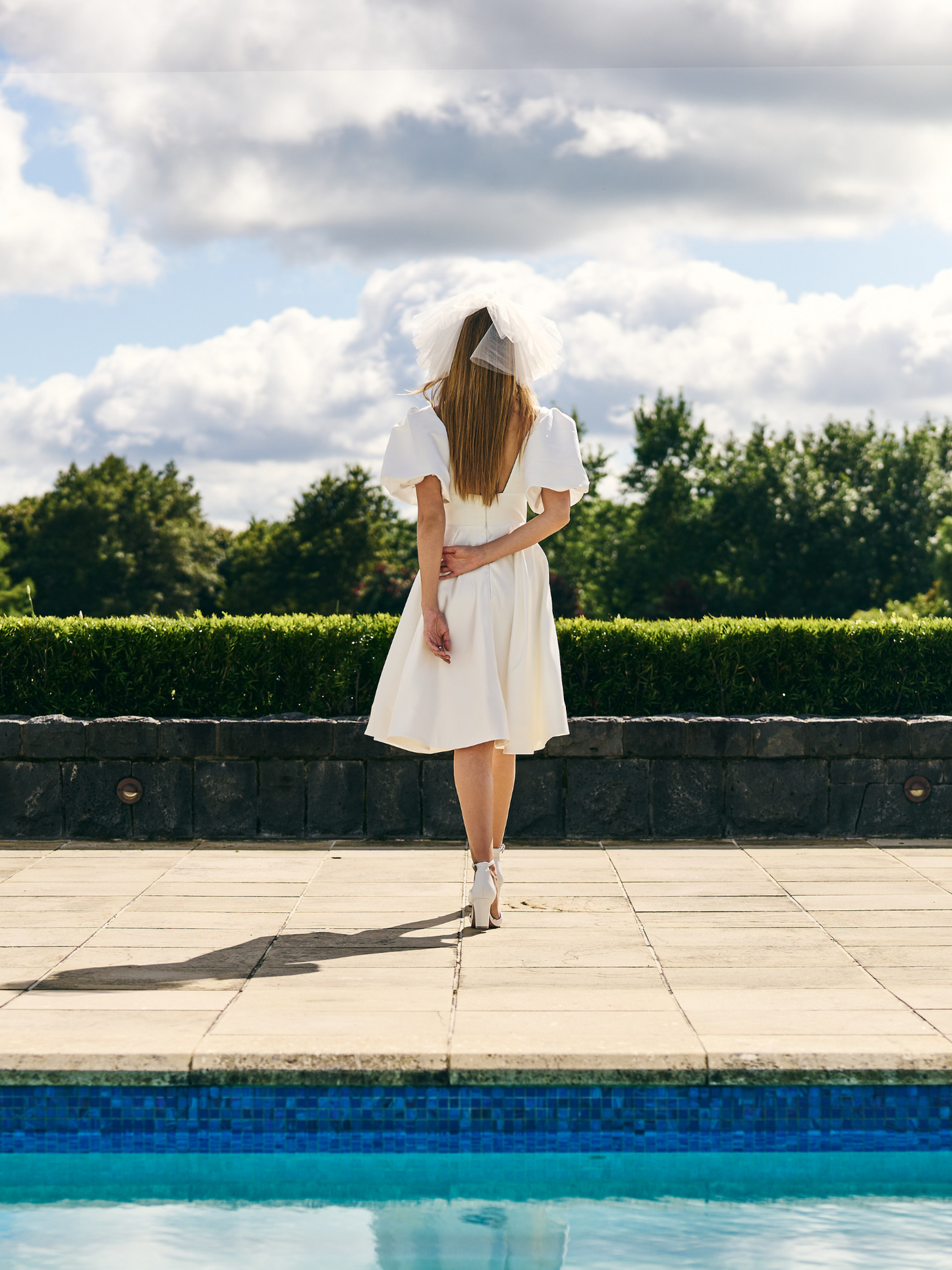 
Mini Bridal dress A-line skirt with puffed three quarter sleeves and V neck plunge. 
