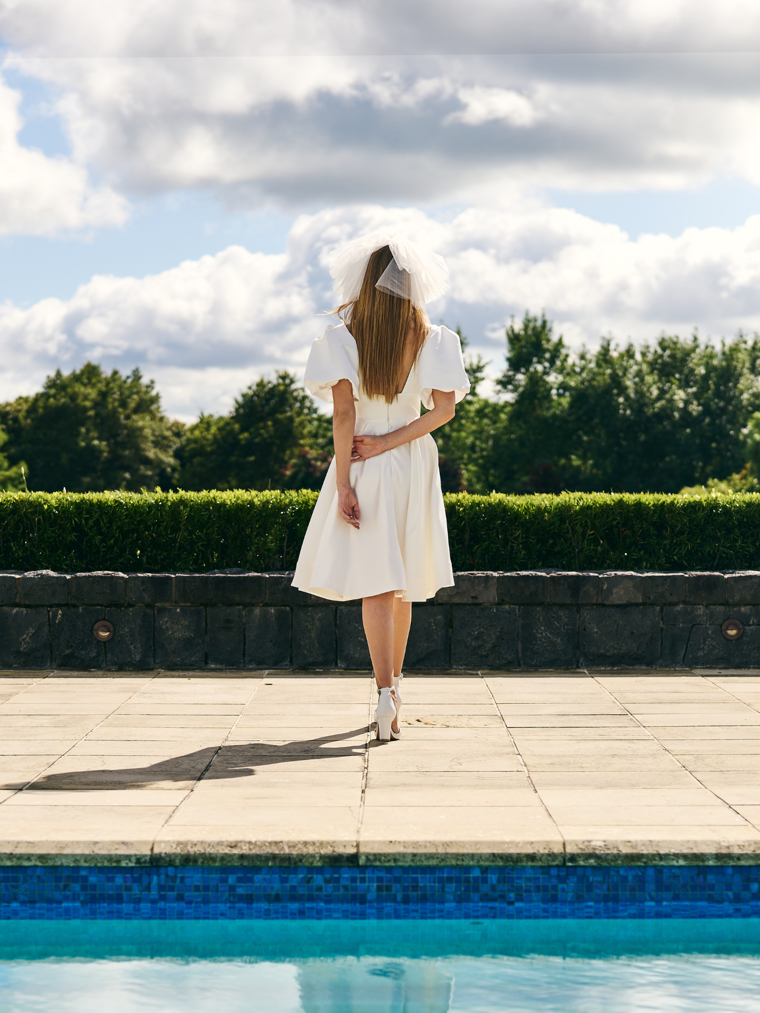 
Mini Bridal dress A-line skirt with puffed three quarter sleeves and V neck plunge. 
