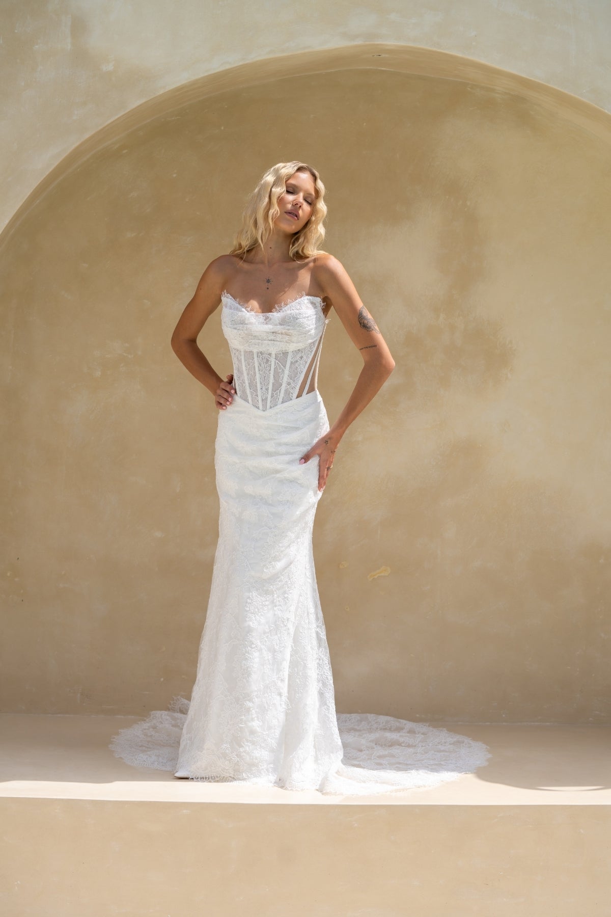 fitted lace wedding gown with ruched bust, sweetheart neckline, and sheer side cut outs with corset boning. featuring a slight basque waist