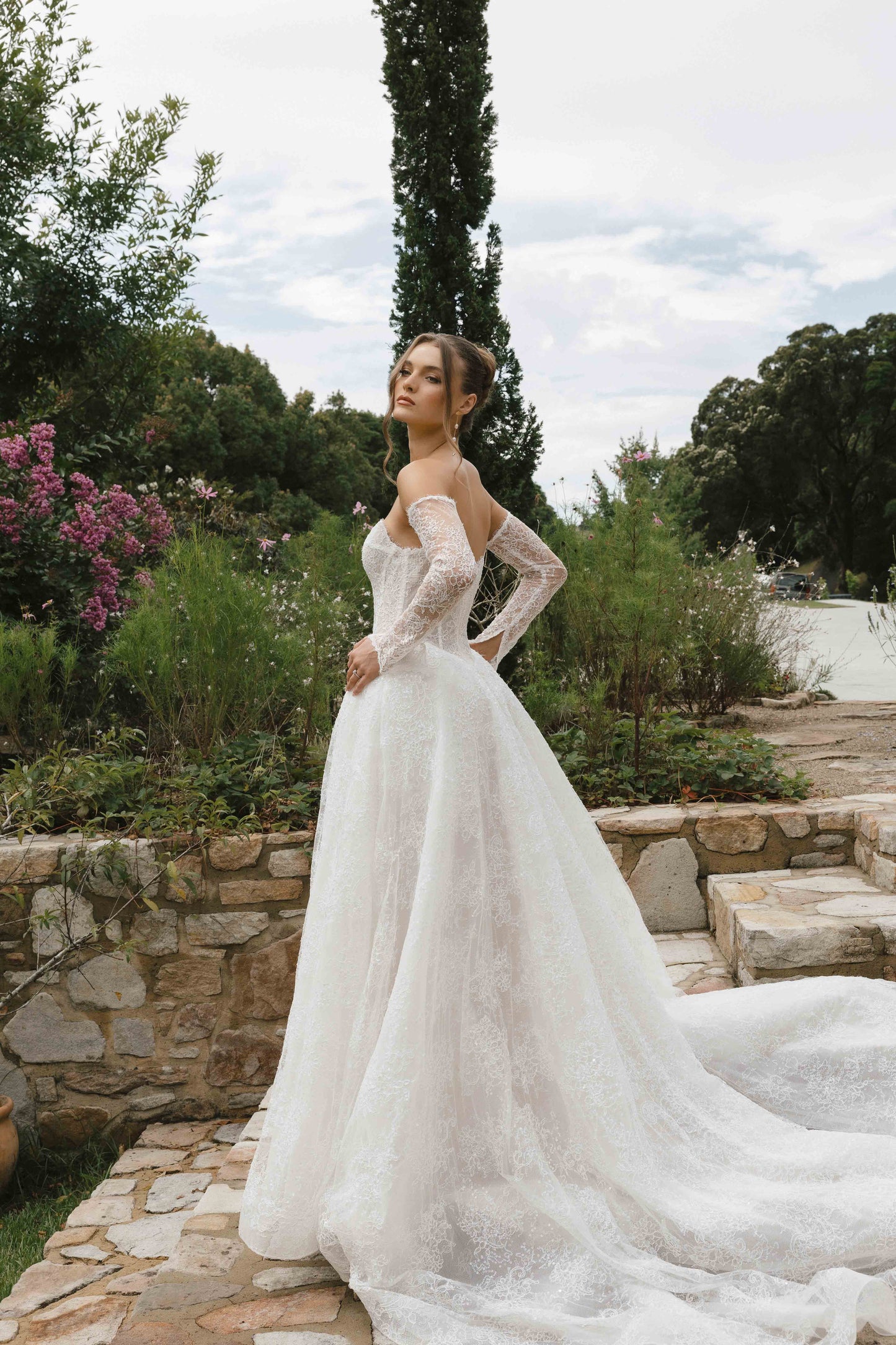 Caitlyn Gown – A-line lace bridal dress with a chapel train, matching lace gloves, and a V-plunge by Roselle collection Jessica Couture