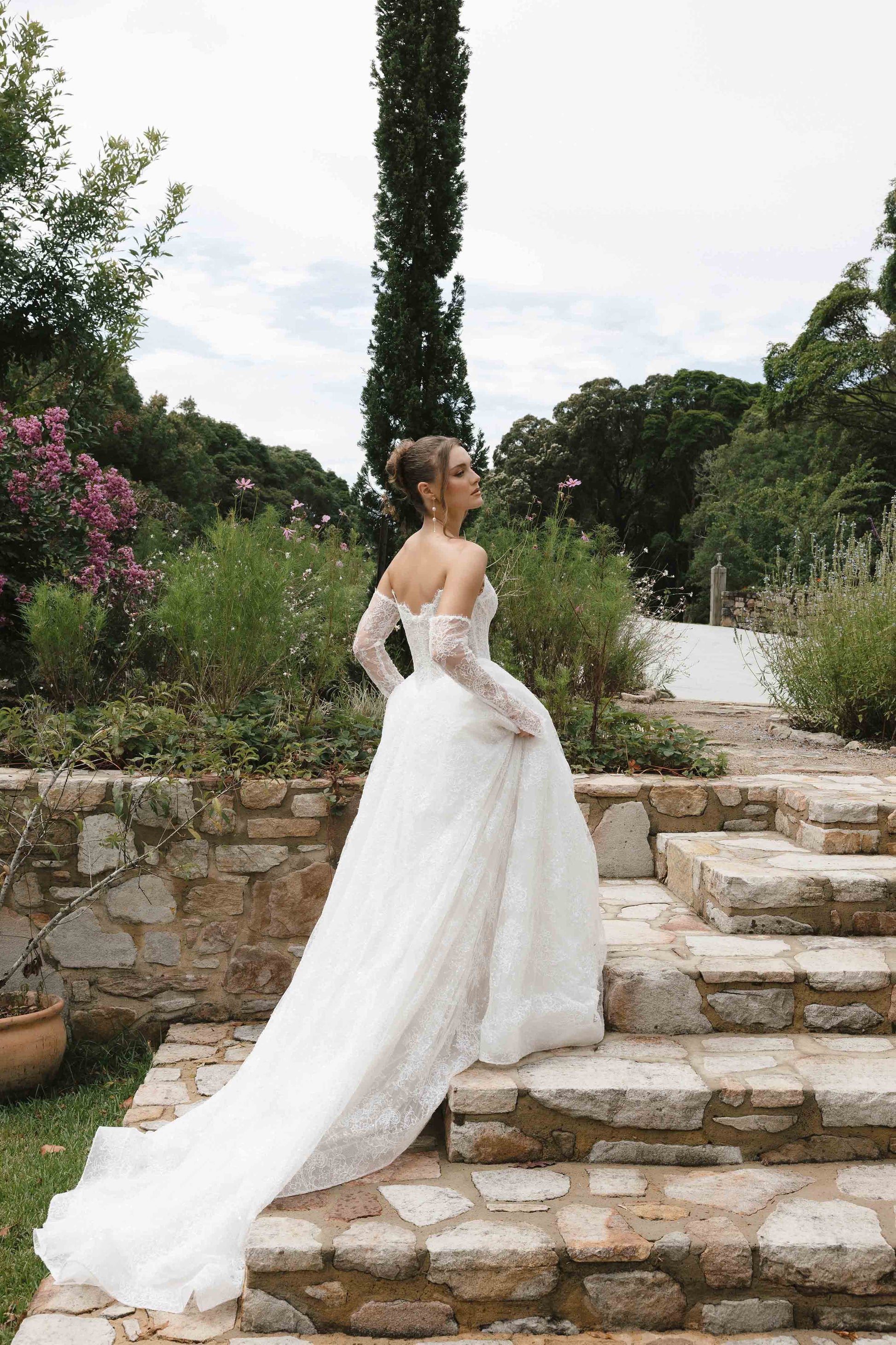 Caitlyn Gown – A-line lace bridal dress with a chapel train, matching lace gloves, and a V-plunge by Roselle collection Jessica Couture