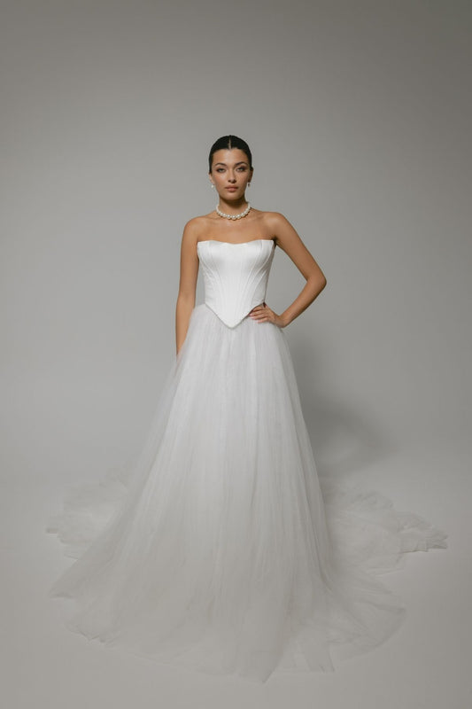 two-piece wedding gown, boned corset top with sharp V basque waist, paired with a pleated voluminous tulle skirt 