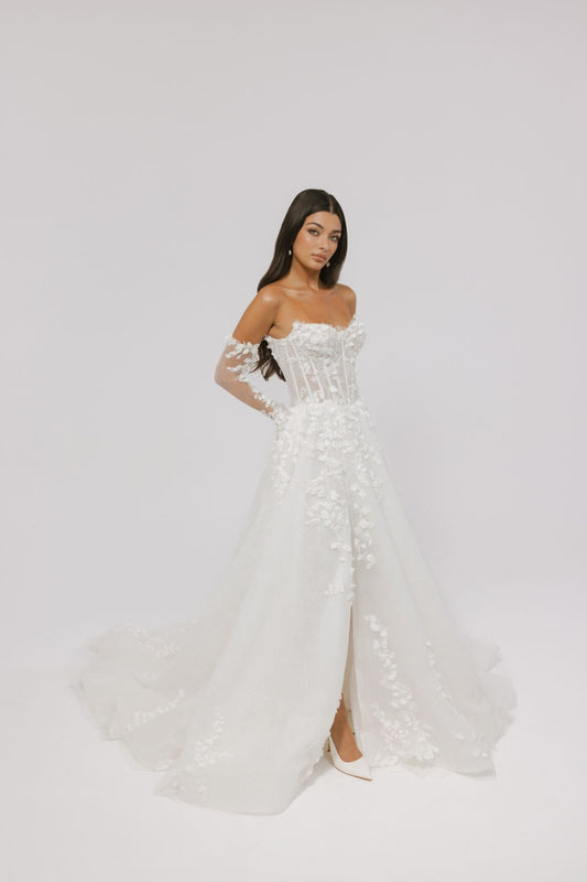 floral wedding gown with corseted bodice, A line skirt featuring split. paired with matching floral lace sleeves 
