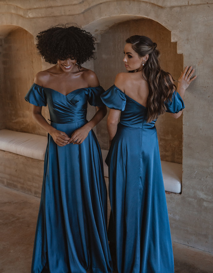 Full length satin bridesmaid dress in peacock blue. Front and back views with off-the-shoulder puffed sleeves