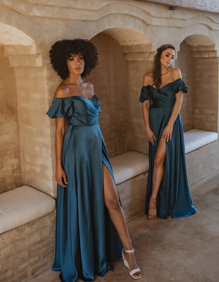 Peacock blue satin bridesmaid dresses with front split in skirt and off-the-shoulder puff sleeves.