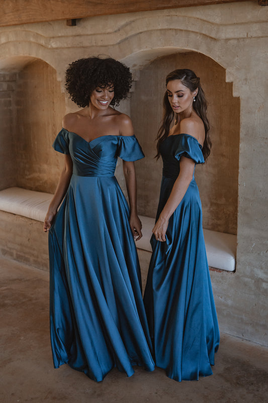 Lagos bridesmaid dress with corset bodice and off-the-shoulder puffed sleeves. Pictured here in peacock blue