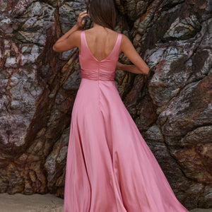 Back view of sakura gown with V-backline and ruched waistband with full-length skirt in pink satin fabric